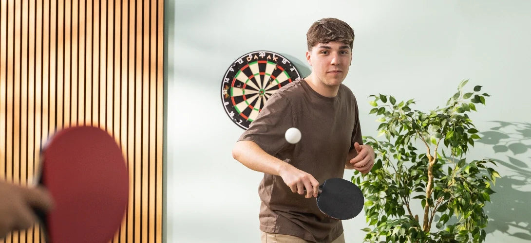 a teenage boy playing table tennis