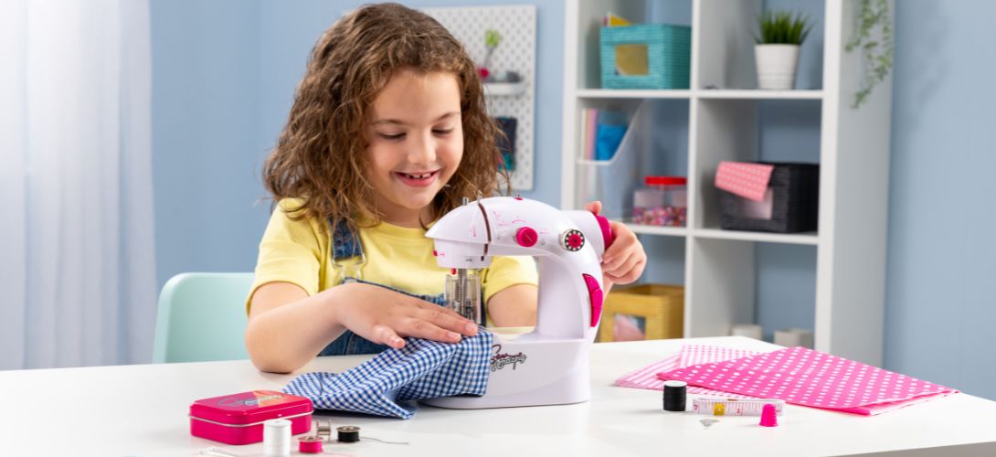 a photo of a young girl at a sewing machine sewing with navy gingham fabric