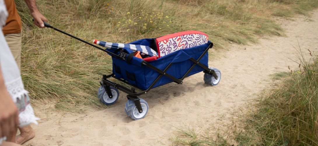 A photo of a navy beach trolley being pulled along some sand