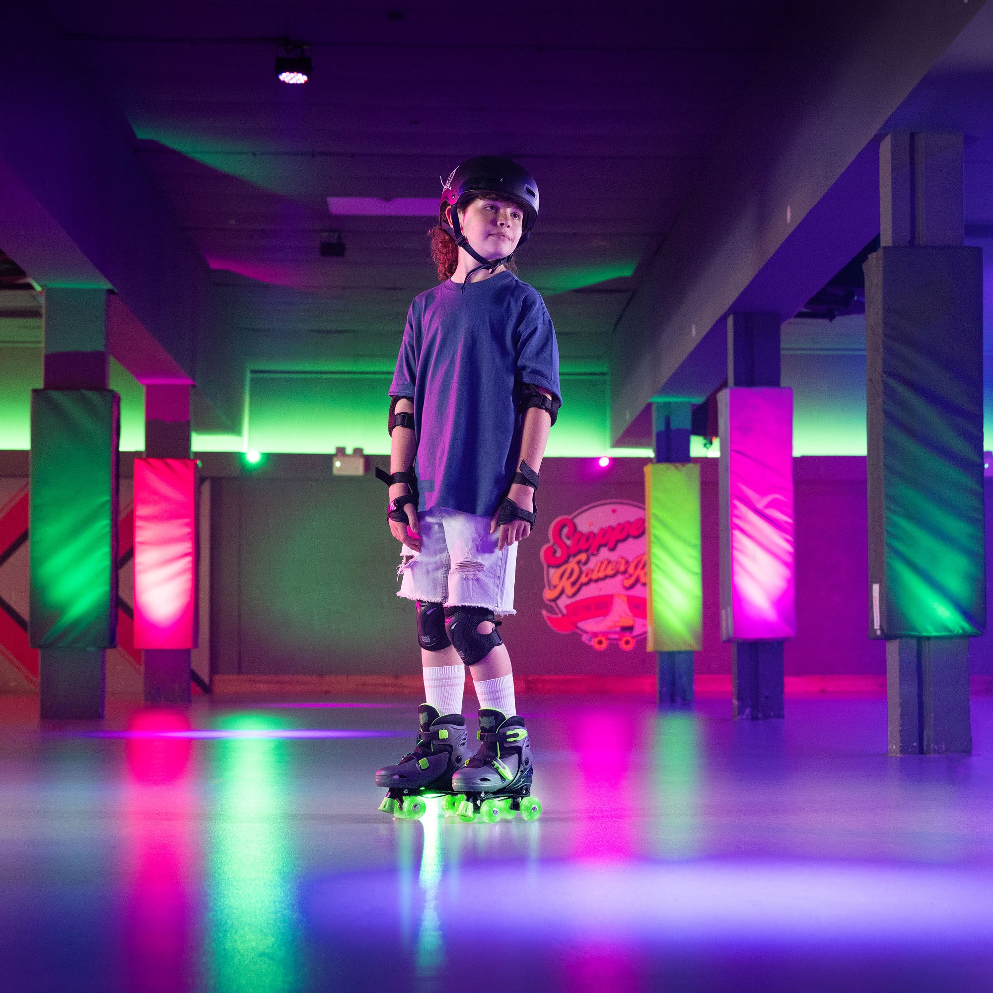 Person on roller skates in a colourful indoor setting with neon lights.