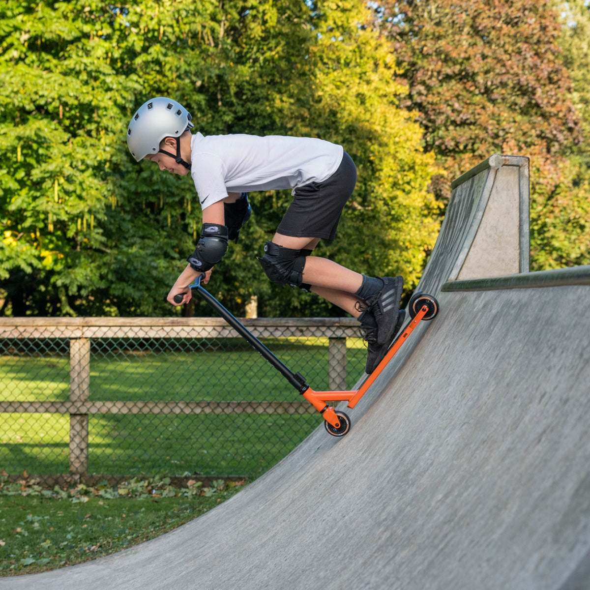 Bright orange scooter for skate tricks