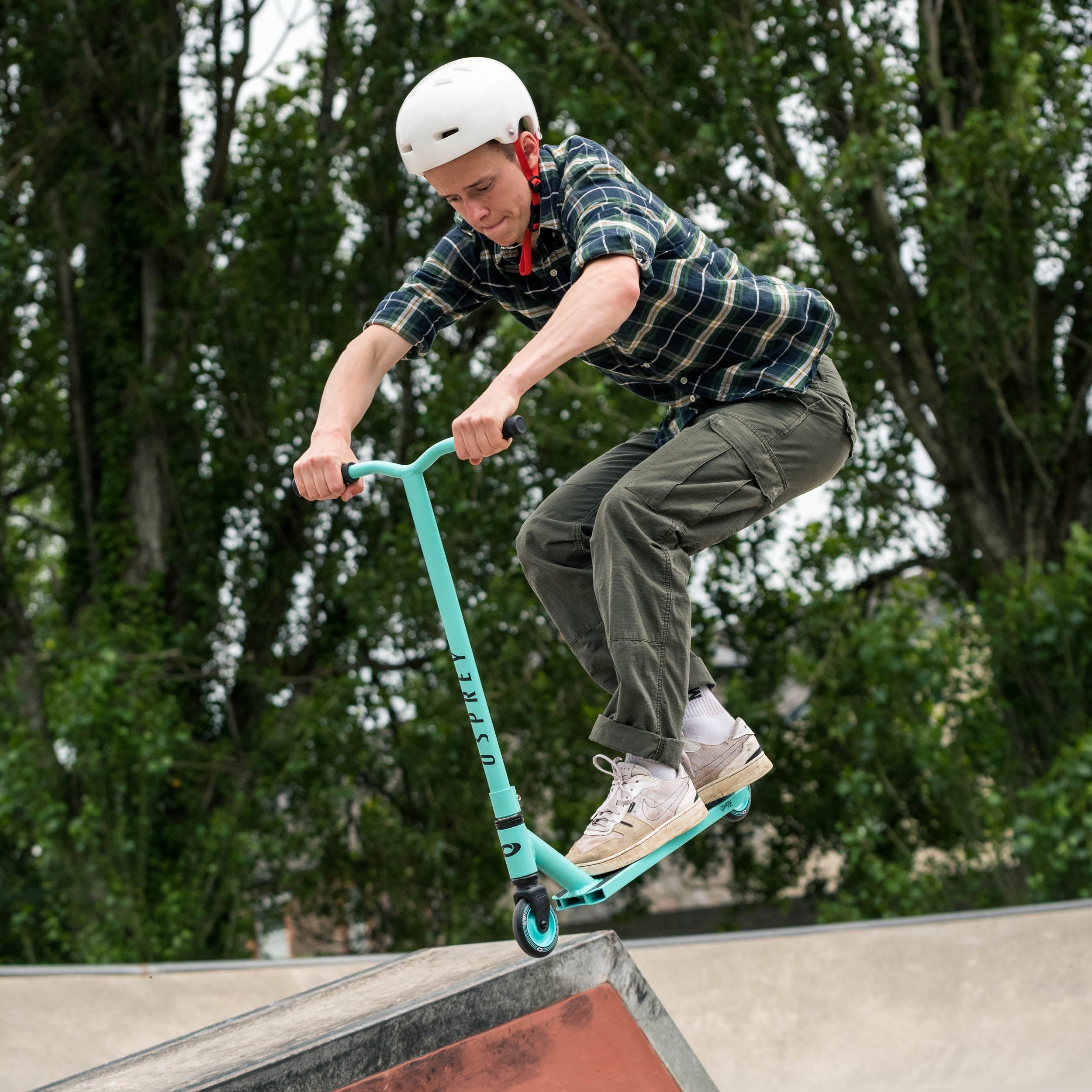 Teal stunt scooter for beginner riders